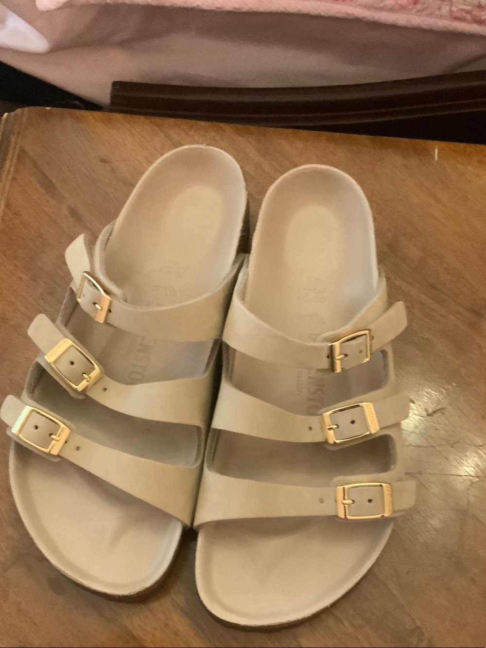 Birkenstock  womens Triple-Strap Sandals in Light Beige with Gold Buckles